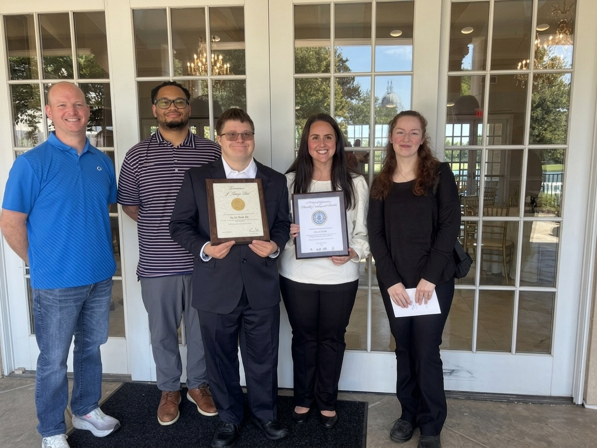 Aaron and the Sam's Club team holding their Governor's Disability Employment Awards